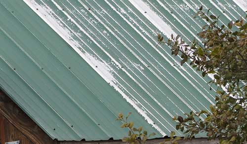 teal colored standing seam metal roof