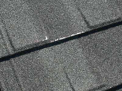 Failed stone coating on metal roofing