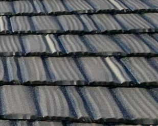 A close-up of panels of steel roofing, which is a charcoal grey color.
