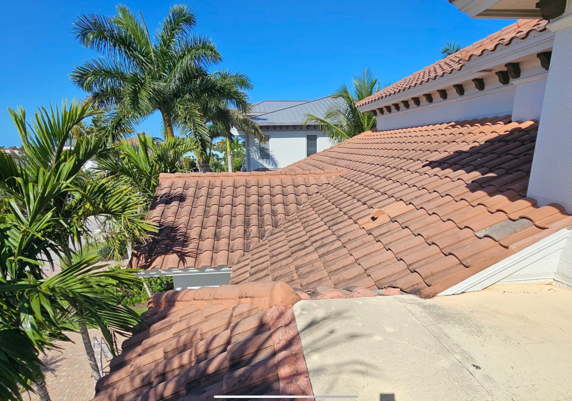 before photo of old spanish clay tile roofing